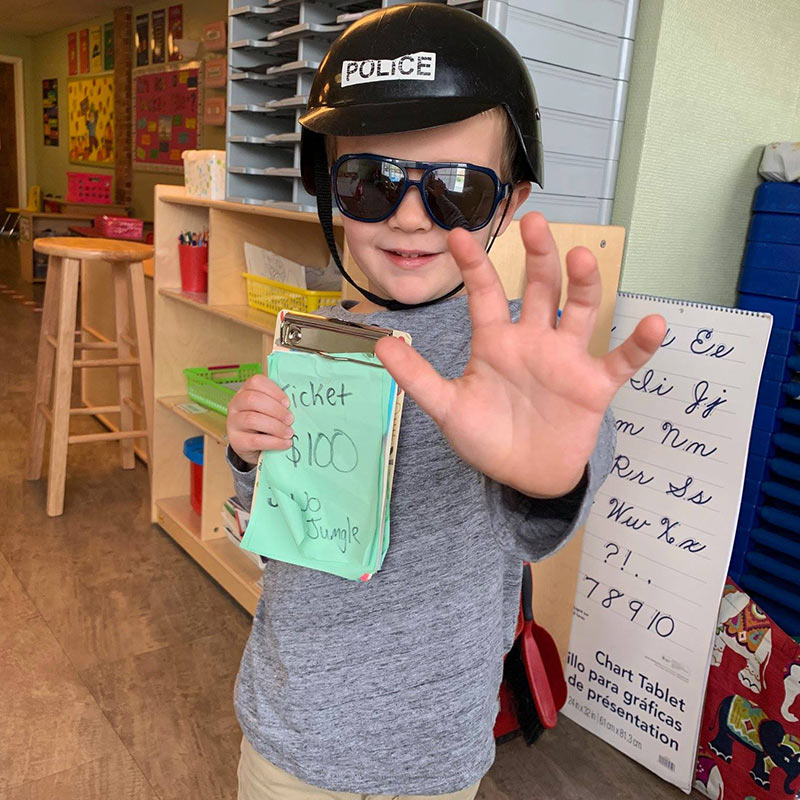 Boy holding ticket dressed in policeman outfit